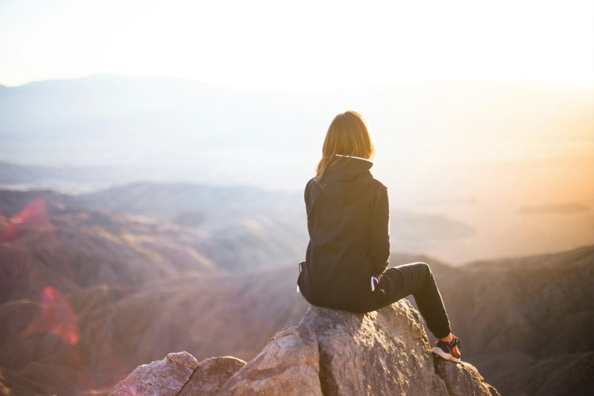 Woman sitting on a stone